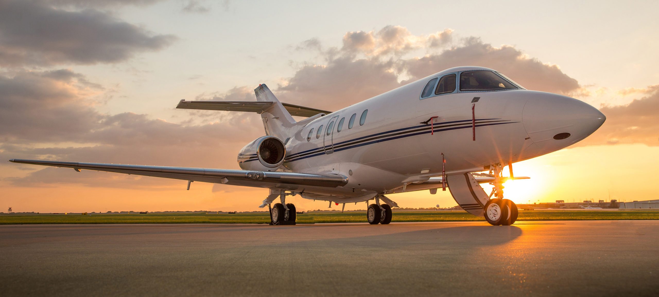 Private aircraft on tarmac at sunset