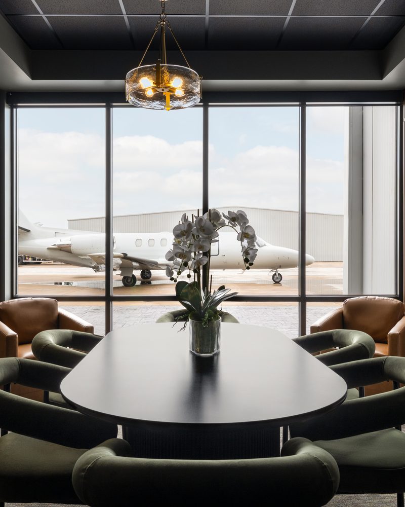 Lone Star Aviators passenger lounge with a business jet on the ramp beyond the glass